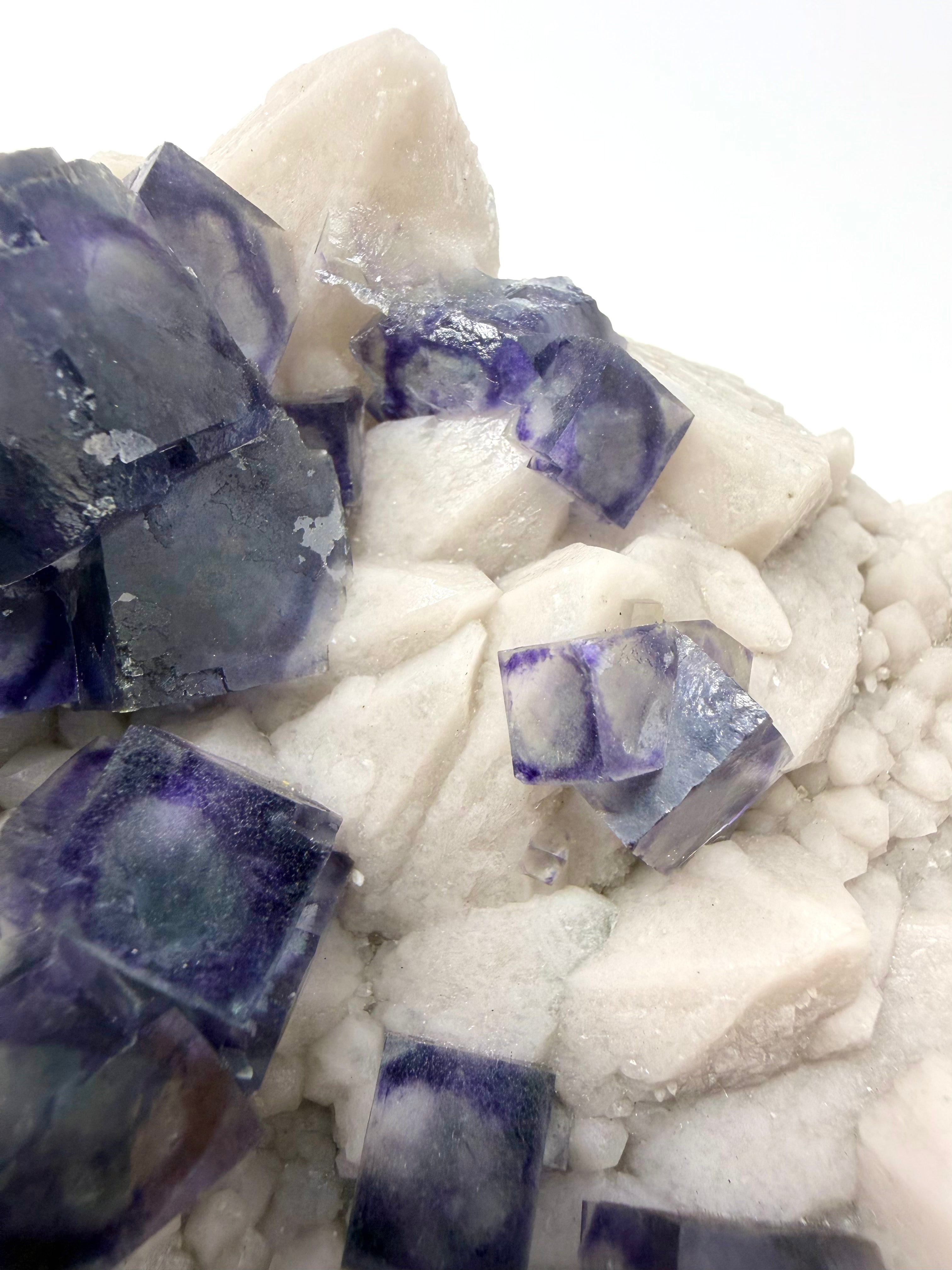 Purple Zoned Fluorite over Milky Candle Quartz