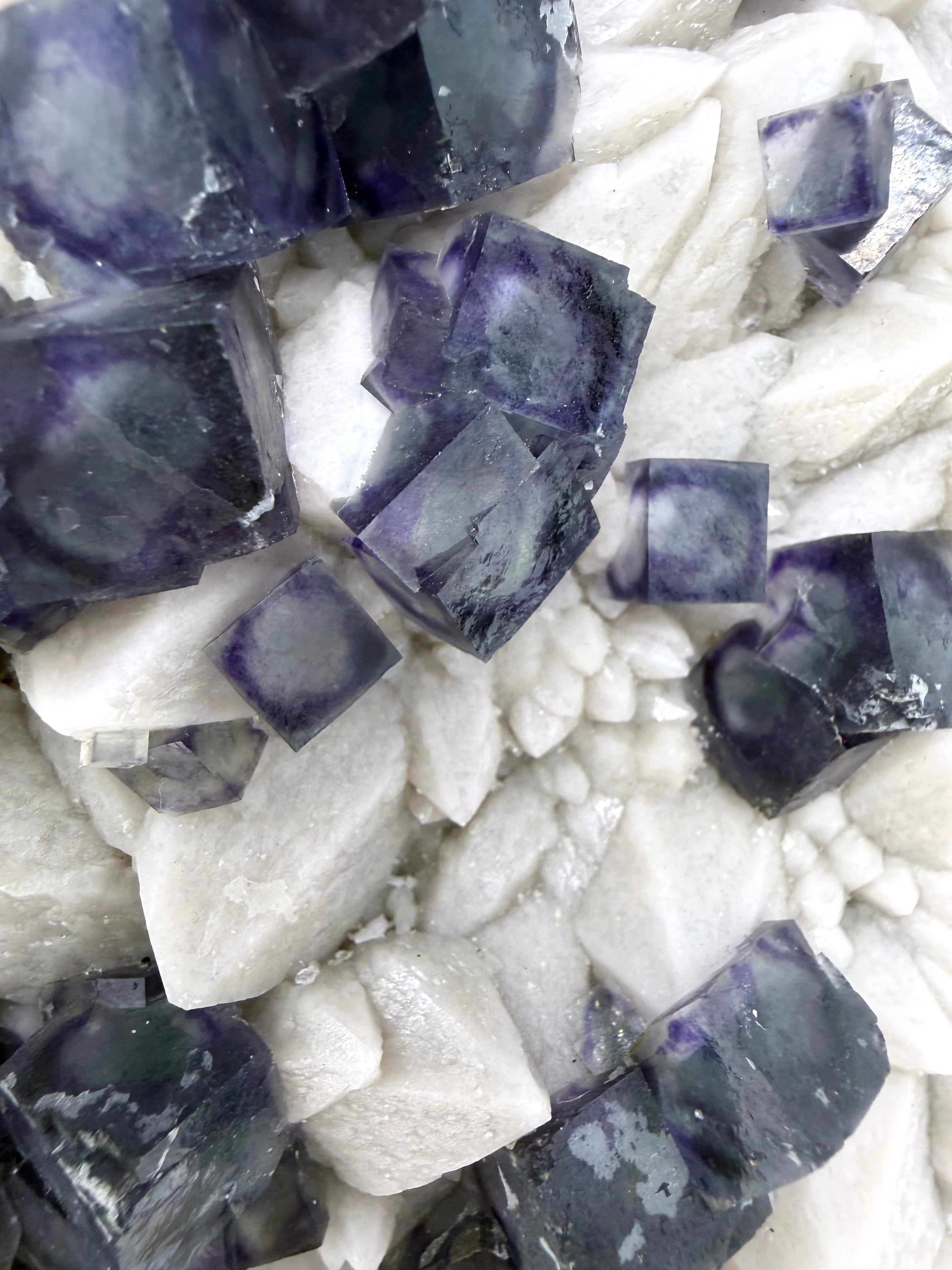 Purple Zoned Fluorite over Milky Candle Quartz