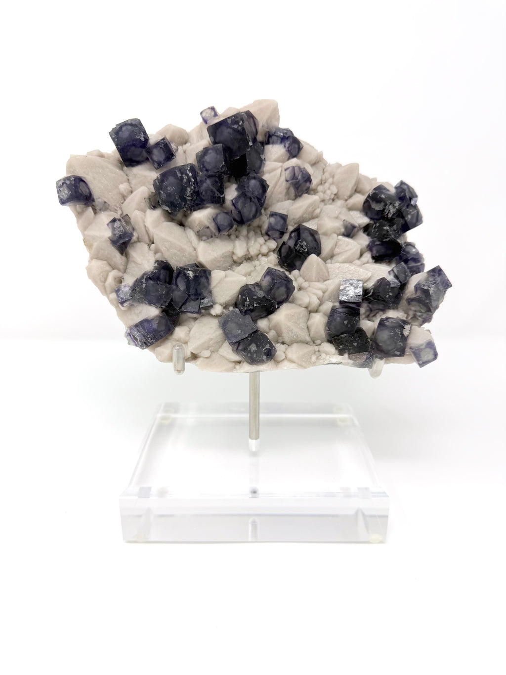 Purple Zoned Fluorite over Milky Candle Quartz