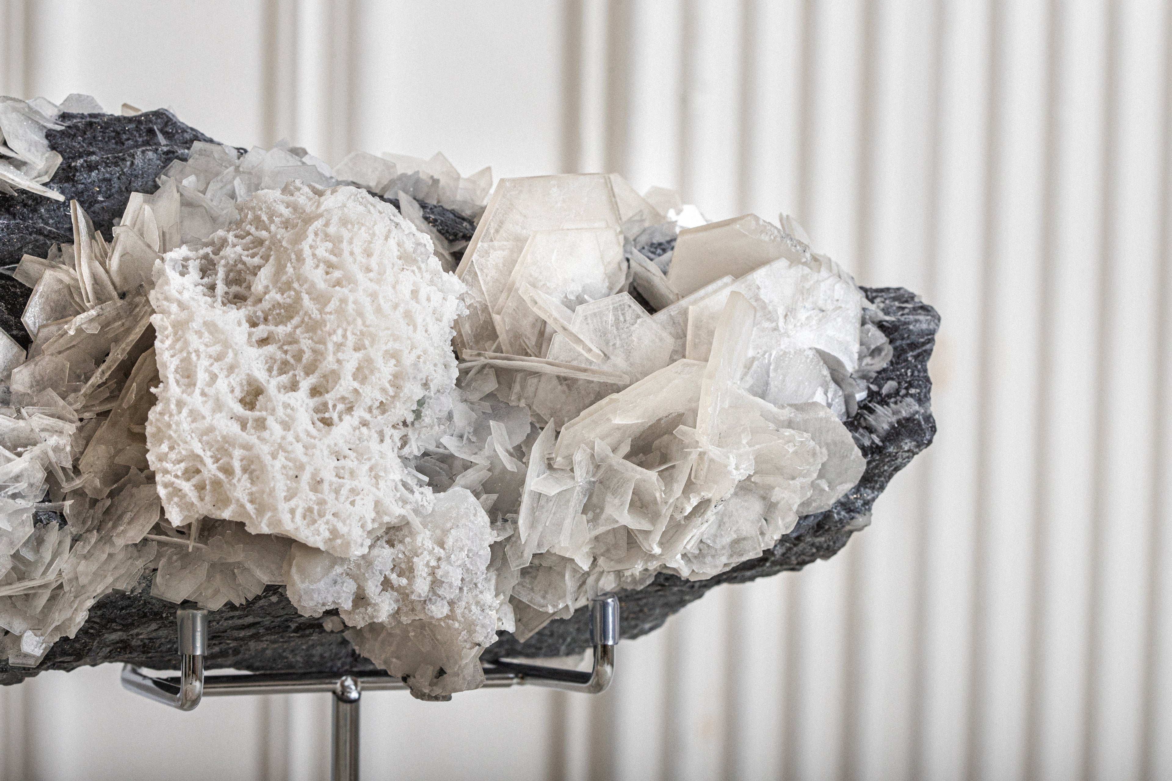 Mineral specimen on a stand with a white background